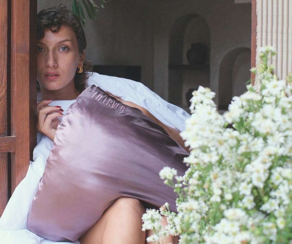 Model sitting in a Bali villa with a LATRAVLA Sojourn PillowWrap