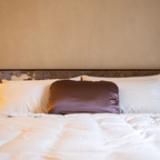 LATRAVLA PillowWrap in Sojourn on a hotel bed.