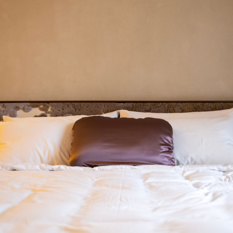 LATRAVLA PillowWrap in Sojourn on a hotel bed.