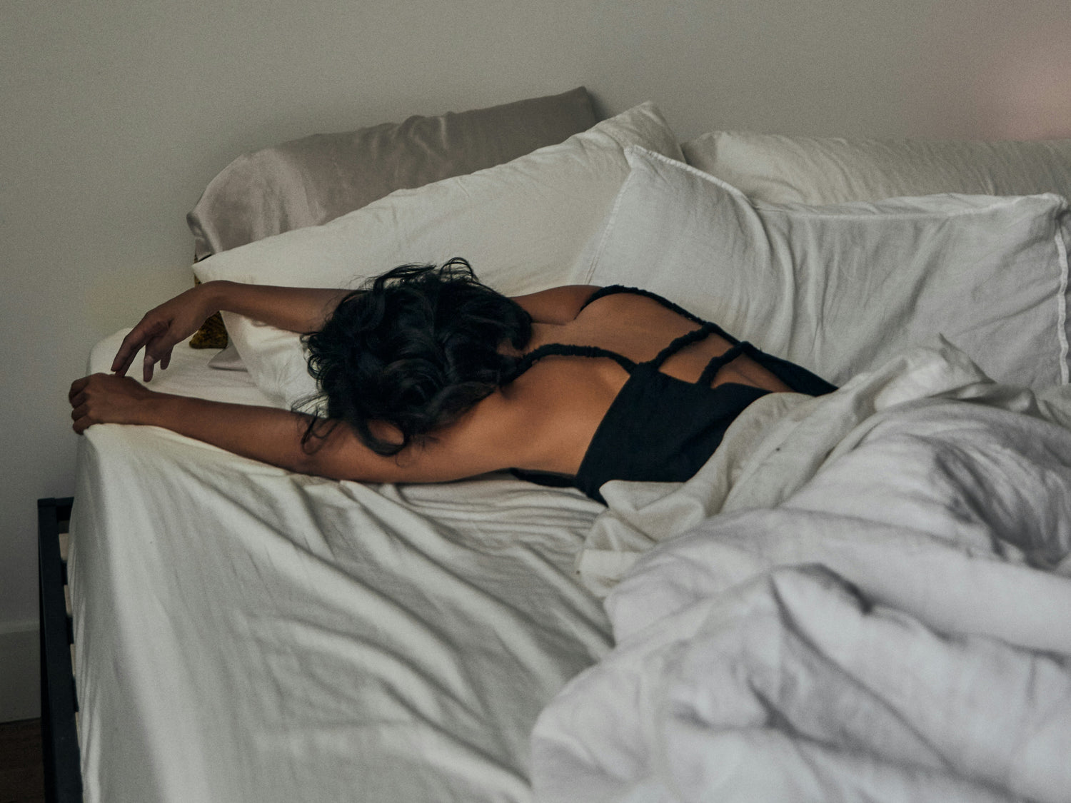 Girl laying in bed with a silk pillowcase